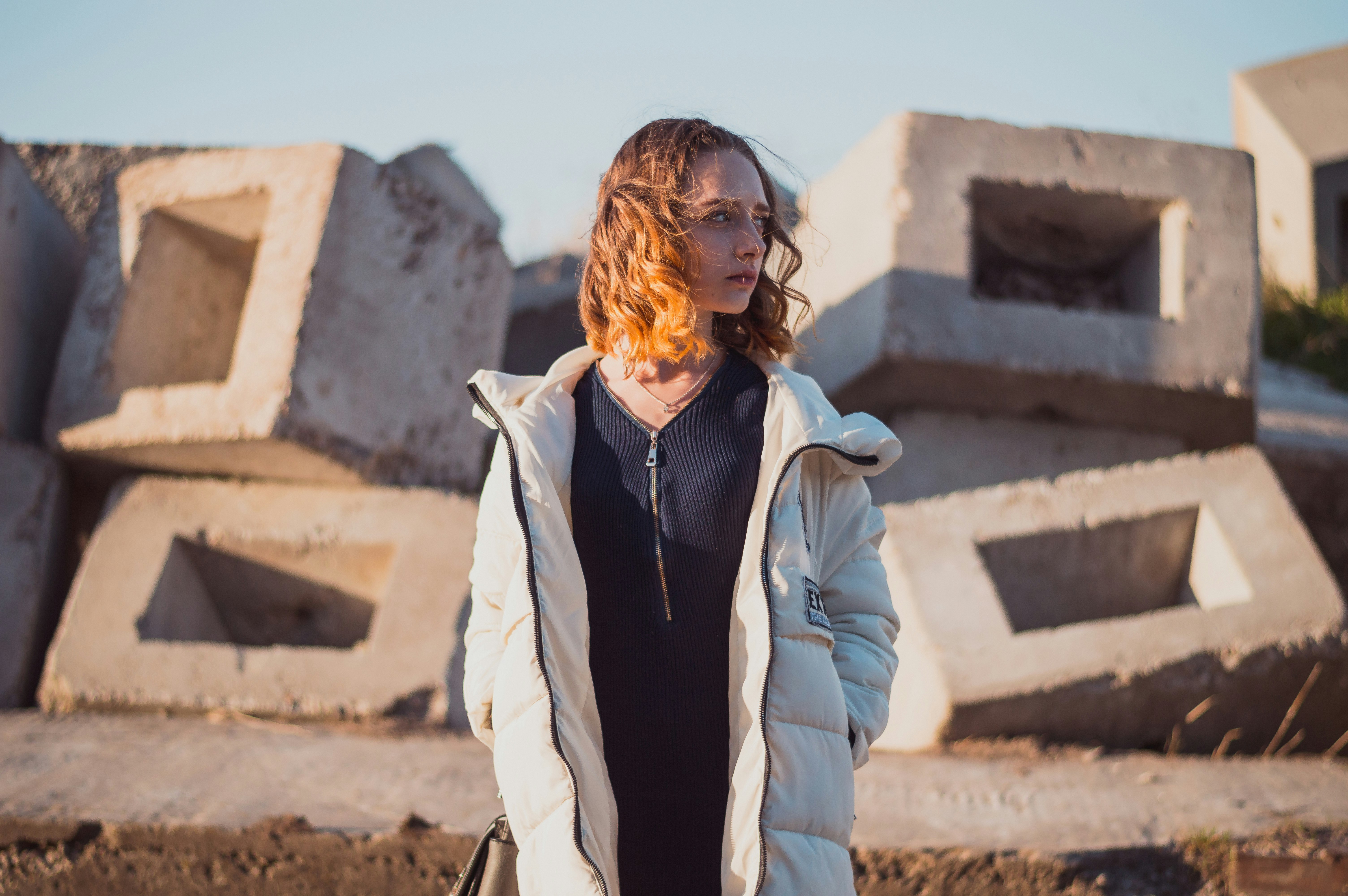 woman in white full-zip bubble jacket standing and looking right side